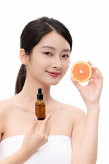 Fototapeta premium Young Woman with Skincare Serum and Orange Slice