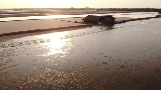 Aerial view of salt harvesting ponds over coastal Thailand, crystal salt ponds.