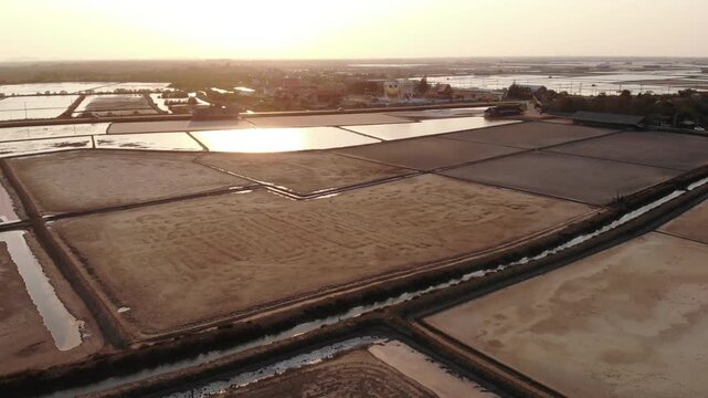 Aerial view of salt harvesting ponds over coastal Thailand, crystal salt ponds.