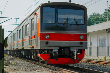 Obraz premium a commuter train passing along the rail line of Java Island, Indonesia