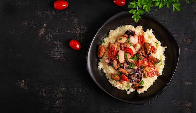 Seafood Risotto with Octopus and Mussels on Dark Background. Top view