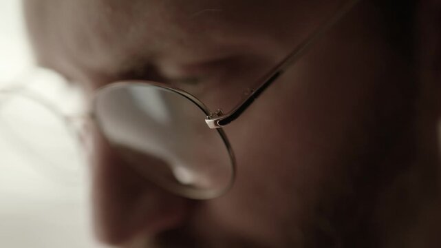 Man eyes at work. Man typing on laptop, conducting research, reading, and coding. Remote work, computer work, concept research.
