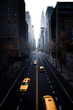 New York City Midtown Manhattan downtown view with classic yellow cabs on 42nd Street seen from Tudor City Bridge, NYC, New York, USA