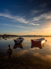 Fototapeta premium Fishermen''s boats in a bay in the sunset