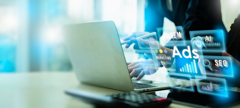 Digital marketing ads and online advertising concept with futuristic HUD. Professional men using laptop for SEO, SEM, AI assistant, and data analytics to optimize social media marketing campaign