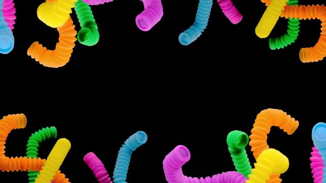 A colorful arrangement of stretchy ribbed colorful plastic flexible tubes against a black background, These are colorful plastic sensory fidget tubes designed for tactile stimulation and stress relief