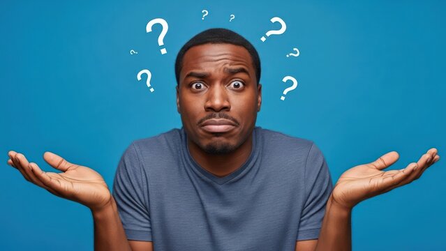 Bewildered dark-skinned man under a shower of inquiry pondering a solution with open palms