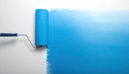 Obraz premium Blue paint roller applying fresh coat on white wall, ideal for renovation and interior design themes.
