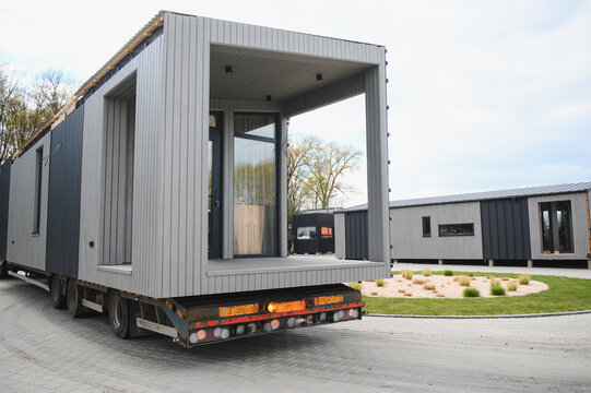 Modular home being transported by truck trailer