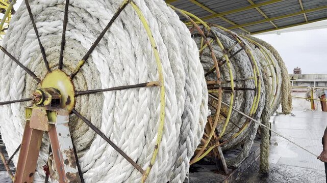 Large Marine Rope Spool on Red Metal Winch Frame at Cargo Pier Thailand
