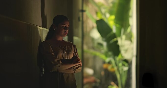 Indian young adult gen z sad stress woman look upset feel bad fail hurt head ache in dark living room. Alone tired female girl think deep suffer low health issue lost job guilt indoor house home place