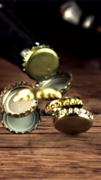 Super slow motion beer lids fall on the table and rotate. On a wooden background.Filmed on a high-speed camera at 1000 fps.