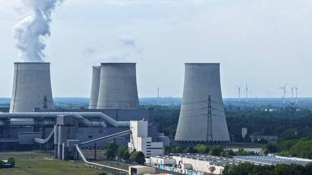 This high-resolution aerial photograph captures a large thermal power plant with its distinctive hyperbolic cooling towers prominently featured. Thi