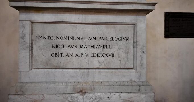 Ascending shot highlighting the tomb of Niccol&ograve; Machiavelli inside Santa Croce in Florence, Italy. Marble sculptures and refined ornamentation reflect Renaissance artistic heritage.