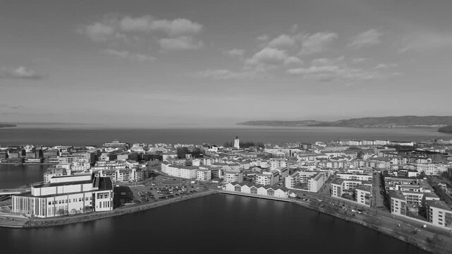 Black and white aerial drone shot of Jonkoping showing waterfront city skyline with Spira Culture Center and Lake Vattern in background creating classic urban panorama