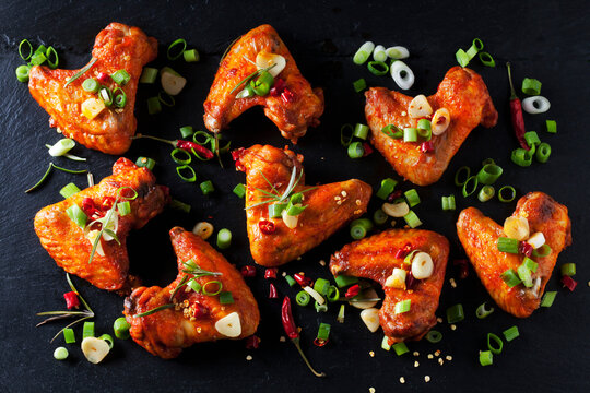 Marinated and grilled chicken wings on slate