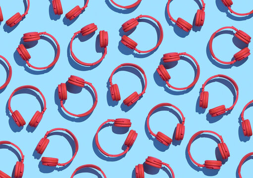 Collection of red wireless headphones on light blue background, 3D Rendering