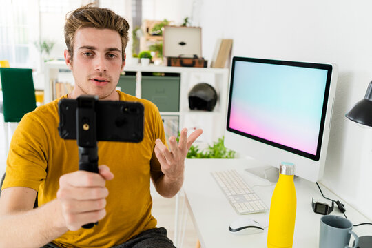 Fitness trainer talking on live streaming while sitting at home