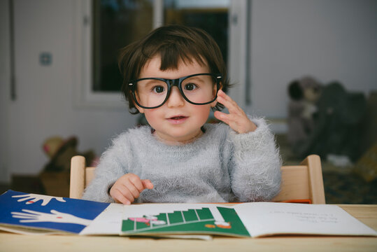 Portrait of relaxed baby girl wearing oversized glasses