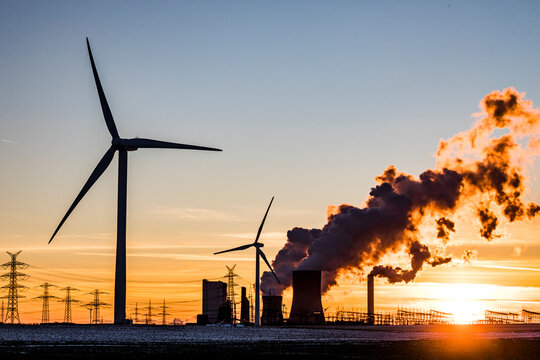 Germany, North Rhine Westphalia, Niederaussem, Wind turbine with lignite power station in background