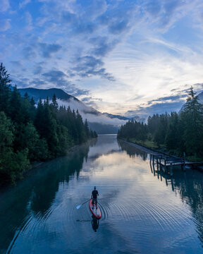 Man on sup board on Lake Plansee in the evening, Tyrol, Austria