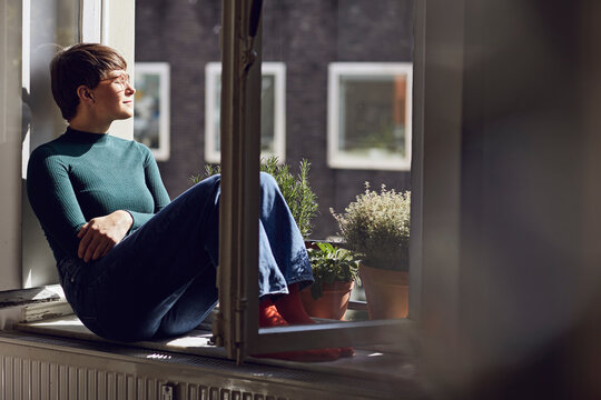 Woman sitting at the window at home