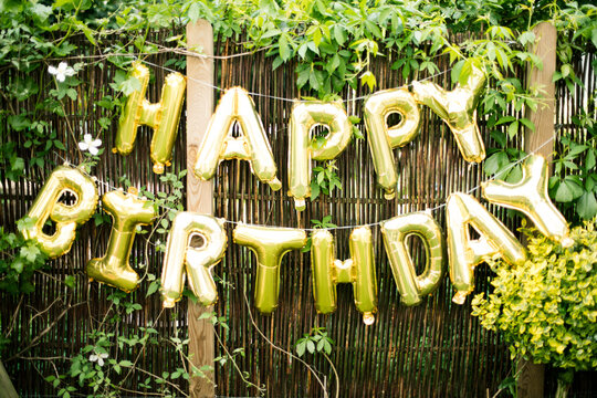 Decoration for Birthday Party in garden with golden balloons