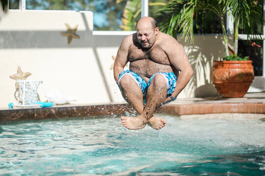 Man jumping in swimming pool