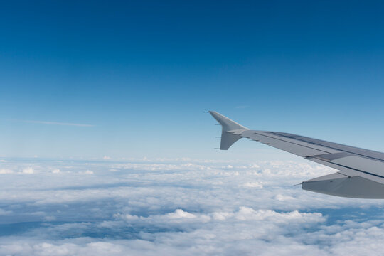 Germany, wing of an airplane with clouds