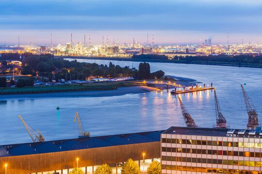 Belgium, Flanders, Antwerp, View to dock area with industrial area at Scheidt river in the evening