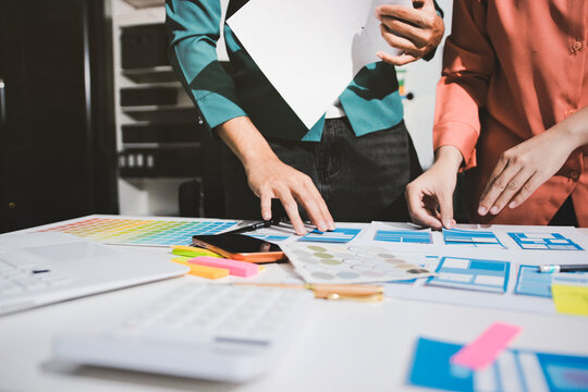 UI designer and UX developer brainstorm idea to design the application appearance in the early stage. Creative digital development agency. UX UI concept