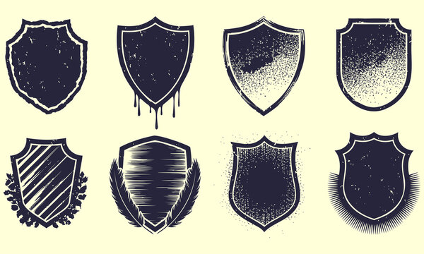 Grunge shield emblems with distressed textures and spray paint effects on a light background