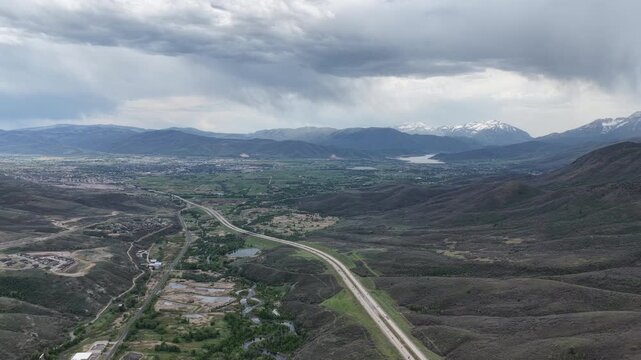 High wide aerial of Deer Valley ski resort along highway 189 in Utah Wasatch Range in spring