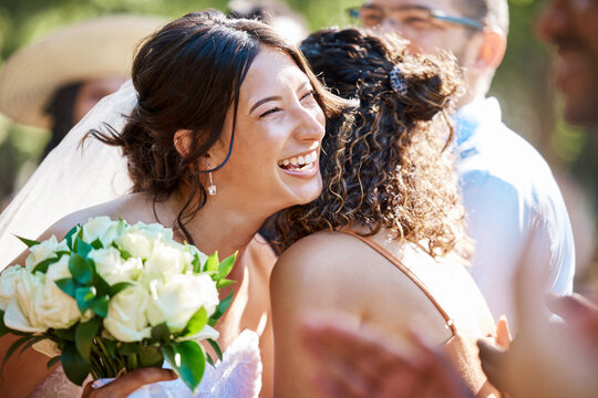Bride, hug and flowers outdoor on wedding day for celebration at marriage ceremony or reception. Bouquet, laughing and thank you with women embracing at function for commitment, solidarity or unity