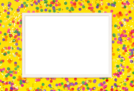White picture frame on yellow background with colorful confetti.