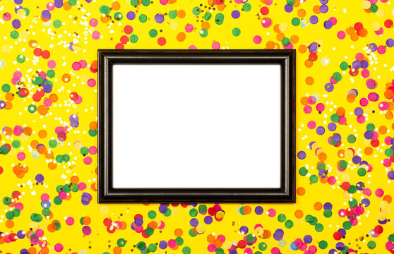 Black picture frame on yellow background with colorful confetti.