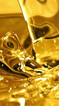 Olive oil pours a whirlpool. Macro background. The texture of olive oil. Filmed is slow motion 1000 fps.