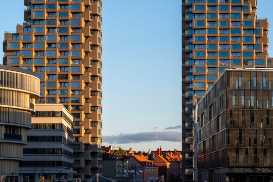 A modern apartment tower rises over Stockholm, Sweden, its residential facade giving the urban city architecture a measured dusk rhythm