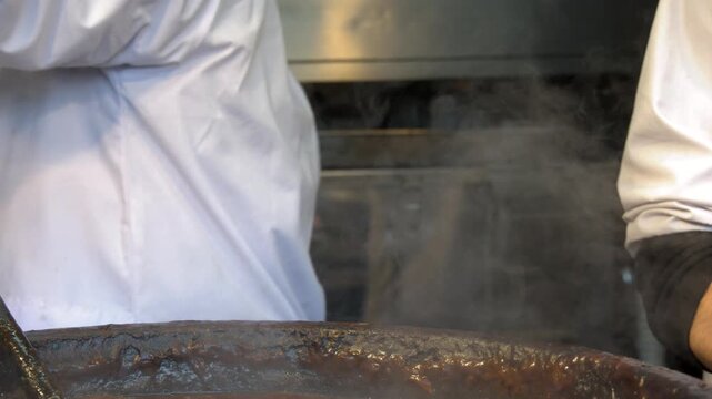 Japanese Chef in White Uniform Stirring Steaming Miso Stew in Large Pot