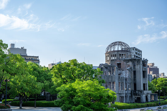 Atomic Bomb Dome Against Blue Sky with Green Trees and Copy Space