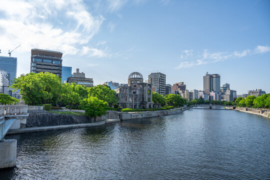 Atomic Bomb Dome Against Blue Sky with Green Trees and Copy Space