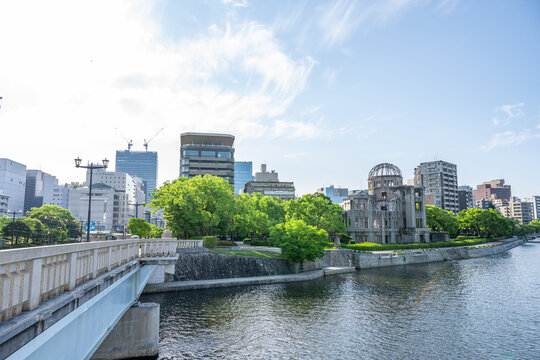 Atomic Bomb Dome Against Blue Sky with Green Trees and Copy Space