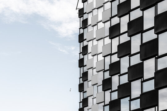 Black and white facade detail in Benidorm, Spain turns modern urban architecture into blue sky geometry across a patterned building edge