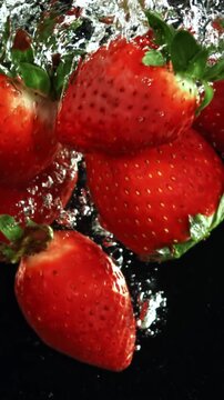 Strawberries fall underwater with bubbles. Filmed is slow motion 1000 fps. High quality FullHD footage