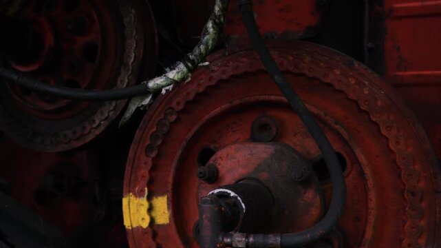 old red combine harvester pulleys for moving belts for threshing wheat barley and soybeans in summer and fall