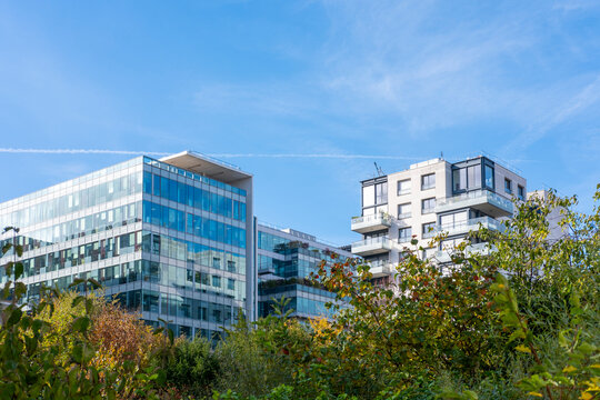 Glass offices, housing and trees shape an urban cityscape in Paris, France, where architecture opens beneath sky across a mixed modern quarter