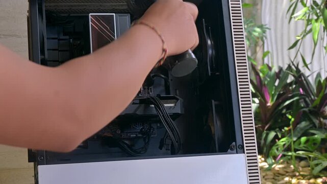 Using Handheld Cordless Air Duster to Clean Computer Chassis Interior