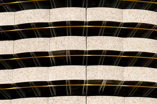 Curved glass bands across a modern building facade make urban architecture feel graphic, balancing reflection, abstract geometry and pattern detail