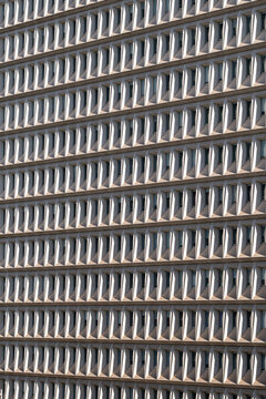 A deep glass facade grid turns a modern building into precise urban architecture, compressing abstract geometry, pattern and surface detail