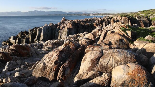 rocky coastline of DeKelders, Gansbaai, South Africa at sunset